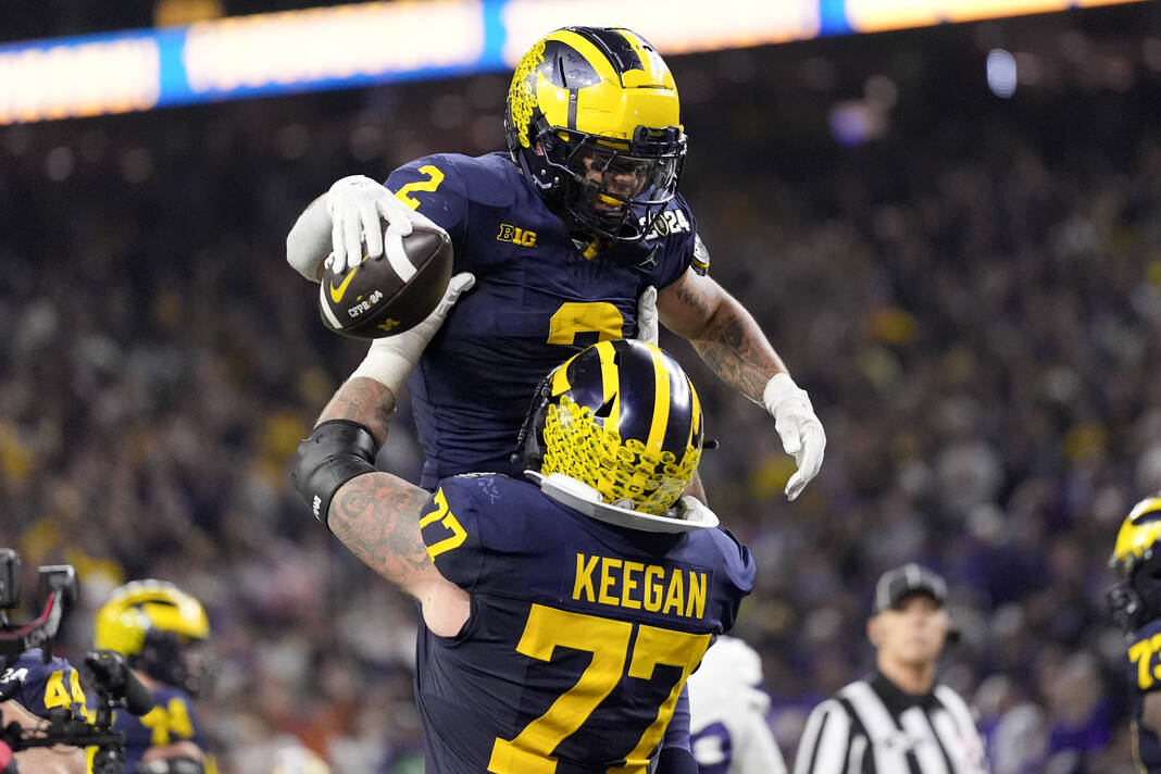 Corum scores 2 TDs Michigan overpowers Washington 34 13